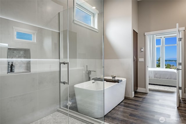 8054 Makah Rd, Birch Bay, WA 98230 - bathroom featuring a soaking tub, wood finished floors, a shower stall, and connected bathroom