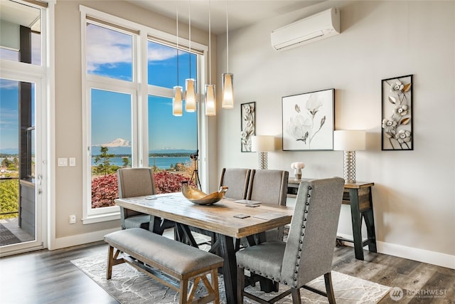 8054 Makah Rd, Birch Bay, WA 98230 - dining area with an AC wall unit, wood finished floors, a water view, and a high ceiling