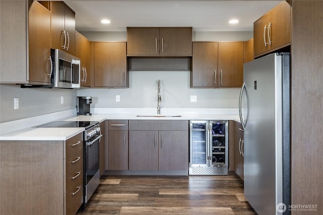 8054 Makah Rd, Birch Bay, WA 98230 - kitchen with appliances with stainless steel finishes, beverage cooler, dark wood-type flooring, light countertops, and recessed lighting