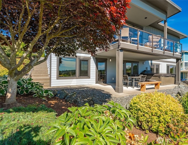8054 Makah Rd, Birch Bay, WA 98230 - rear view of property featuring a hot tub, a balcony, a patio, and board and batten siding