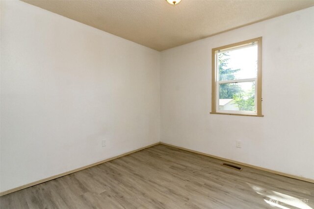 28312 22nd Ave S, Federal Way, WA 98003 - unfurnished room featuring light wood-style floors and baseboards