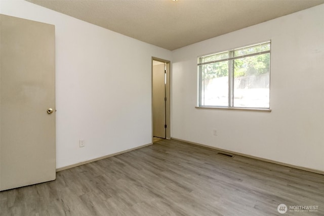 28312 22nd Ave S, Federal Way, WA 98003 - empty room featuring wood finished floors and baseboards