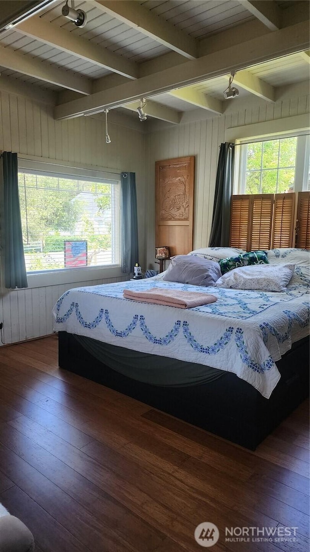 3504 L Pl, Seaview, WA 98644 - bedroom featuring hardwood / wood-style flooring, beamed ceiling, multiple windows, track lighting, and wood walls