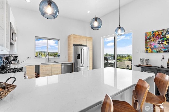 8068 Niska Rd, Blaine, WA 98230 - kitchen featuring stainless steel appliances, healthy amount of natural light, a breakfast bar, modern cabinets, and high vaulted ceiling