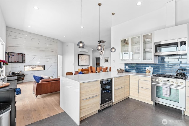 8068 Niska Rd, Blaine, WA 98230 - kitchen featuring appliances with stainless steel finishes, open floor plan, modern cabinets, wine cooler, and recessed lighting