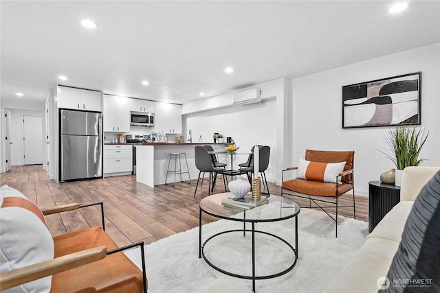 8068 Niska Rd, Blaine, WA 98230 - living room with a wall mounted AC, light wood finished floors, and recessed lighting