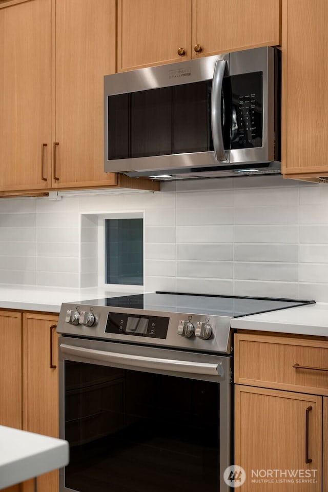10602 NE 137th Pl, Kirkland, WA 98033 - kitchen featuring appliances with stainless steel finishes, tasteful backsplash, and light countertops