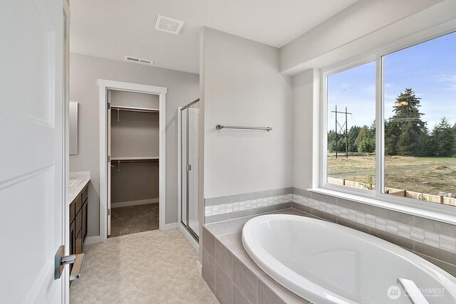 812 Bodie Ct SE, Lacey, WA 98513 - bathroom featuring a bath, a shower stall, plenty of natural light, and a walk in closet