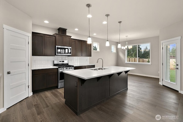 812 Bodie Ct SE, Lacey, WA 98513 - kitchen featuring stainless steel appliances, a chandelier, dark wood-type flooring, dark brown cabinets, and recessed lighting
