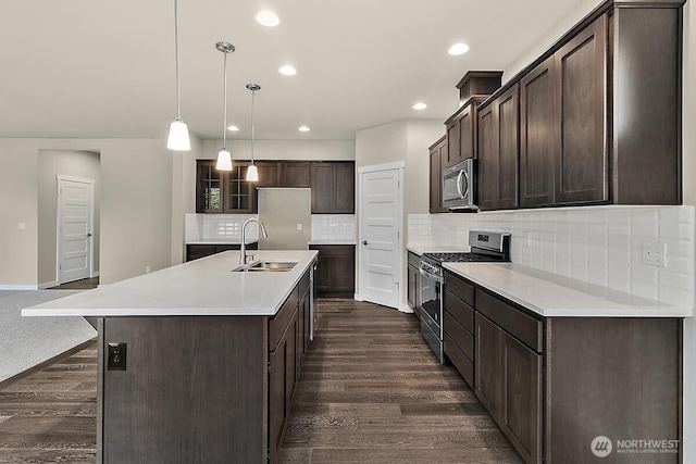 812 Bodie Ct SE, Lacey, WA 98513 - kitchen featuring stainless steel appliances, dark brown cabinets, dark wood-style flooring, tasteful backsplash, and recessed lighting
