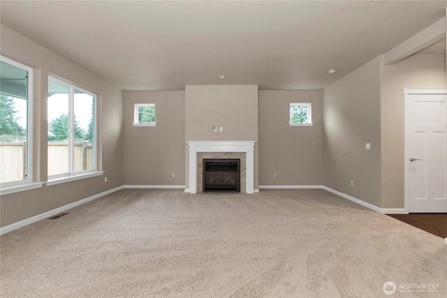 812 Bodie Ct SE, Lacey, WA 98513 - unfurnished living room with plenty of natural light, a tiled fireplace, and carpet