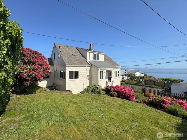 13151/2 W 5th St, Port Angeles, WA 98363 - rear view of property with a chimney and roof with shingles