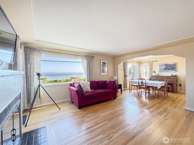 13151/2 W 5th St, Port Angeles, WA 98363 - living area with plenty of natural light, a chandelier, arched walkways, and baseboards