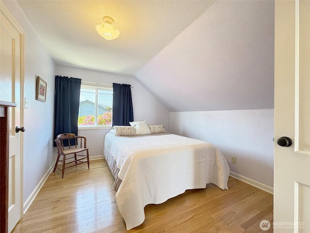 13151/2 W 5th St, Port Angeles, WA 98363 - bedroom with light wood-style flooring, vaulted ceiling, and baseboards