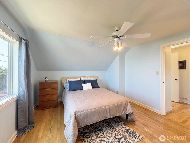13151/2 W 5th St, Port Angeles, WA 98363 - bedroom with light wood-style floors, baseboards, ceiling fan, and vaulted ceiling