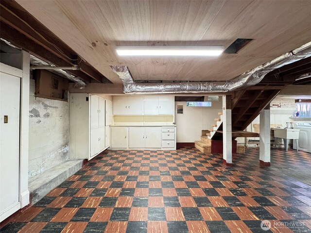13151/2 W 5th St, Port Angeles, WA 98363 - basement featuring dark floors, stairway, and washer / dryer