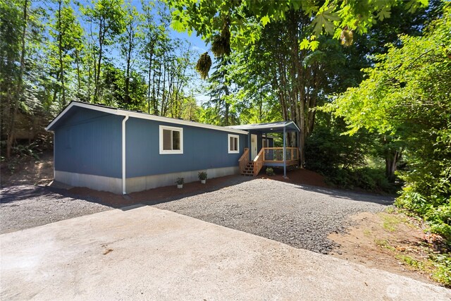 29722 State Highway 3 NE, Poulsbo, WA 98370 - manufactured / mobile home with a porch and view of wooded area