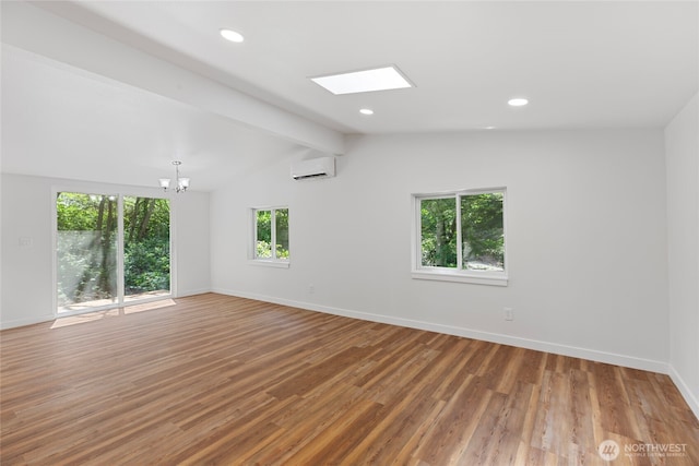 29722 State Highway 3 NE, Poulsbo, WA 98370 - unfurnished room with wood finished floors, baseboards, an AC wall unit, a chandelier, and recessed lighting