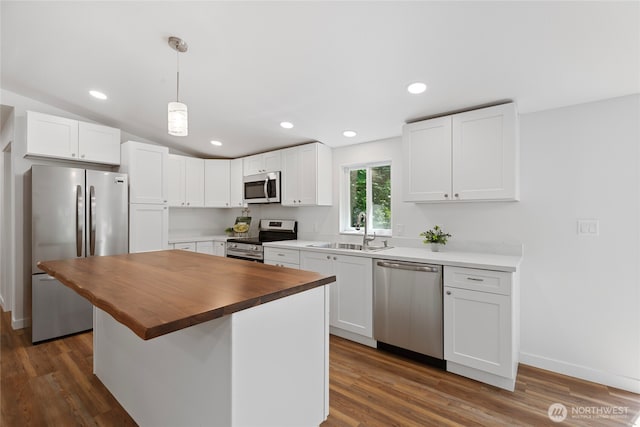 29722 State Highway 3 NE, Poulsbo, WA 98370 - kitchen with appliances with stainless steel finishes, a sink, butcher block countertops, white cabinetry, and dark wood-style flooring