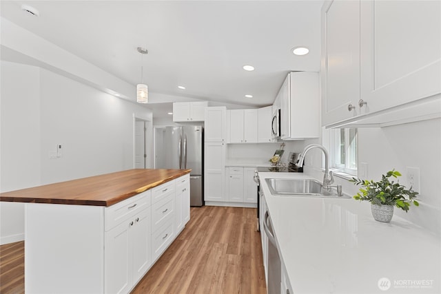 29722 State Highway 3 NE, Poulsbo, WA 98370 - kitchen with butcher block counters, appliances with stainless steel finishes, a sink, light wood finished floors, and recessed lighting