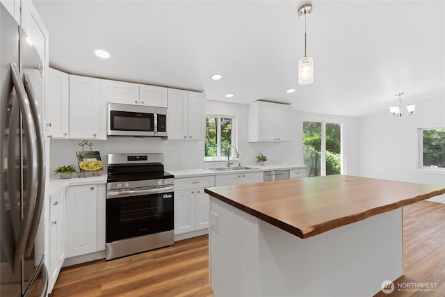 29722 State Highway 3 NE, Poulsbo, WA 98370 - kitchen featuring stainless steel appliances, a sink, butcher block countertops, healthy amount of natural light, and recessed lighting