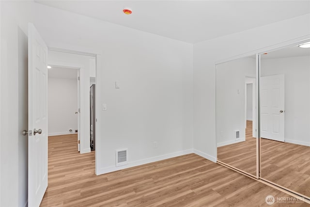 29722 State Highway 3 NE, Poulsbo, WA 98370 - unfurnished bedroom with light wood-style floors, baseboards, and a closet