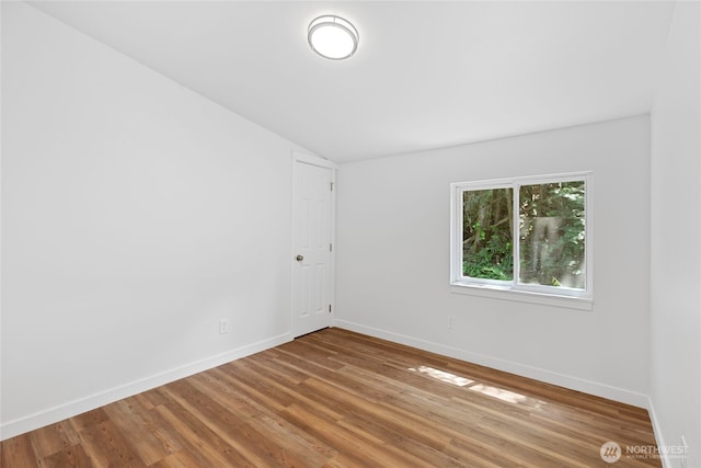 29722 State Highway 3 NE, Poulsbo, WA 98370 - unfurnished room featuring lofted ceiling, wood finished floors, and baseboards