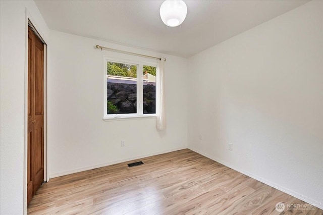 12712 NE 120th St Unit G1, Kirkland, WA 98034 - spare room featuring light wood-style floors and baseboards