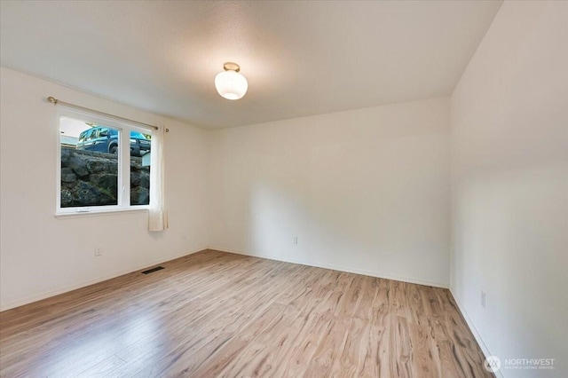 12712 NE 120th St Unit G1, Kirkland, WA 98034 - spare room with wood finished floors and baseboards