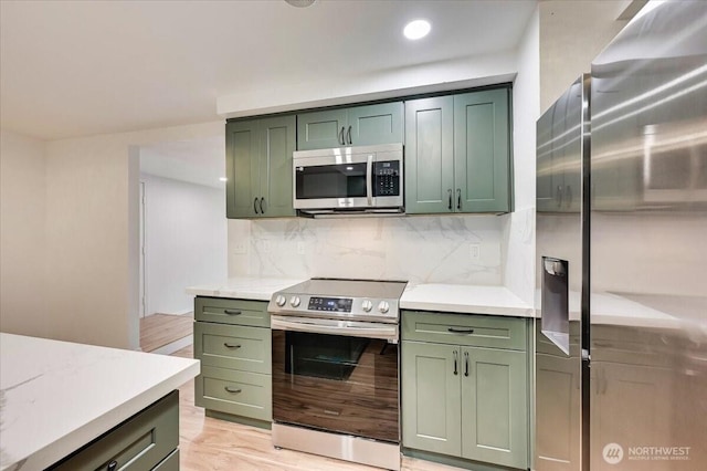 12712 NE 120th St Unit G1, Kirkland, WA 98034 - kitchen featuring green cabinets, appliances with stainless steel finishes, light countertops, and recessed lighting