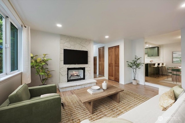 12712 NE 120th St Unit G1, Kirkland, WA 98034 - living area with a stone fireplace, light wood-type flooring, and recessed lighting
