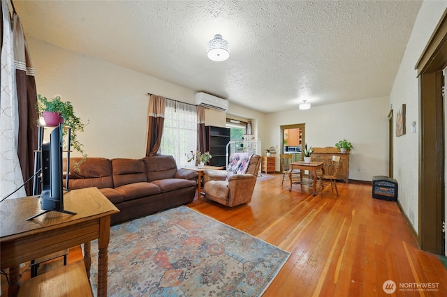 507 S 3rd St, Dayton, WA 99328 - living area featuring a textured ceiling, light wood-style flooring, and a wall mounted AC