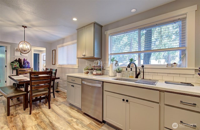 10012 NE 39th St, Vancouver, WA 98662 - kitchen with dishwasher, a sink, a chandelier, light wood-style floors, and decorative light fixtures