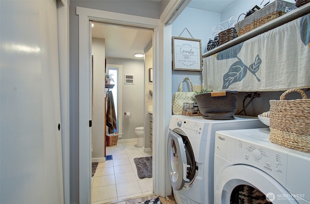 10012 NE 39th St, Vancouver, WA 98662 - laundry room with washing machine and clothes dryer, light tile patterned floors, and baseboards