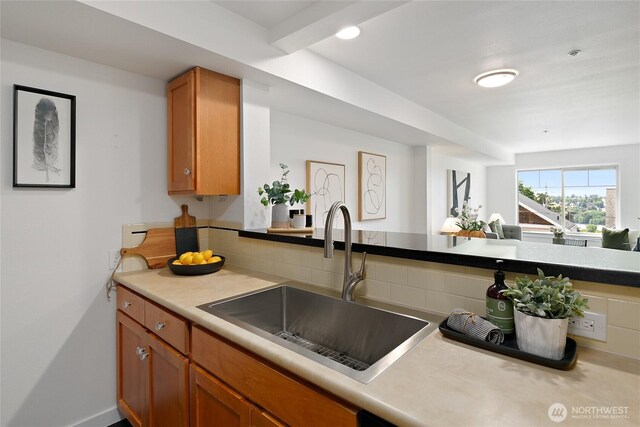 1909 10th Ave W Unit 203, Seattle, WA 98119 - kitchen with a sink, brown cabinetry, and light countertops