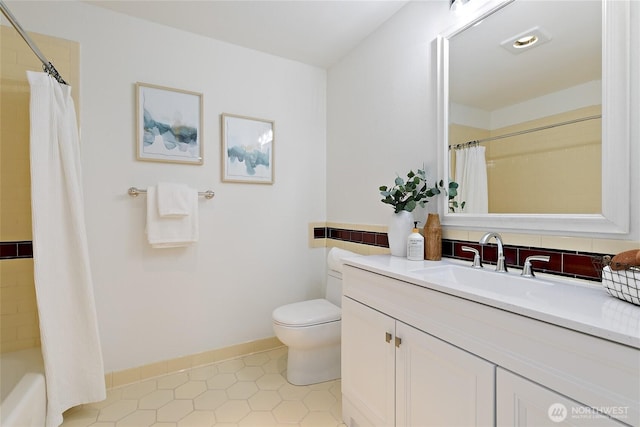 1909 10th Ave W Unit 203, Seattle, WA 98119 - full bath featuring toilet, vanity, tile patterned floors, baseboards, and shower / bath combination with curtain