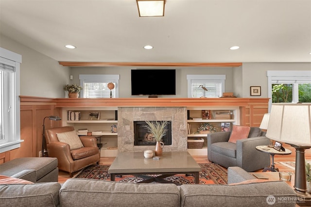 1605 Donovan Ave, Bellingham, WA 98225 - living room with a warm lit fireplace, recessed lighting, wood finished floors, and a wainscoted wall