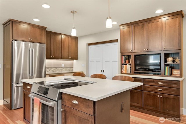 1605 Donovan Ave, Bellingham, WA 98225 - kitchen with stainless steel appliances, a kitchen island, light wood-style floors, recessed lighting, and backsplash
