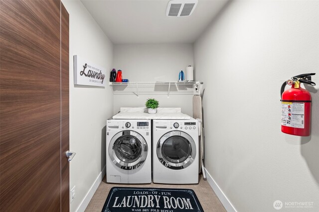 32867 Madrona Ave SE, Black Diamond, WA 98010 - laundry area with washer and clothes dryer and baseboards