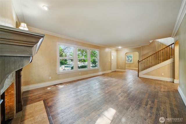 1126 E Alder St, Walla Walla, WA 99362 - unfurnished living room featuring arched walkways, stairway, healthy amount of natural light, wood finished floors, and ornamental molding