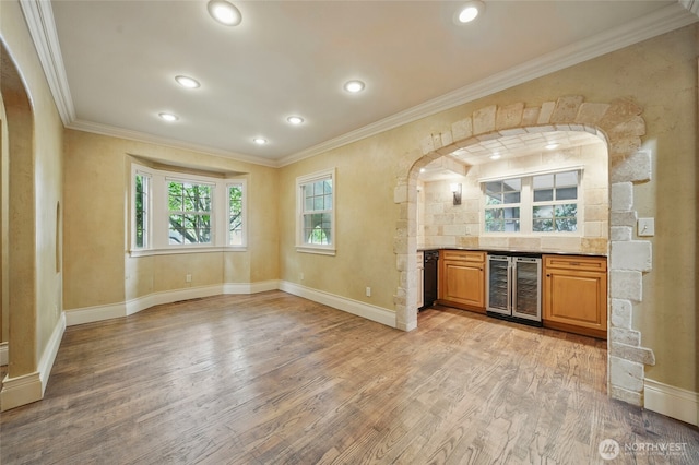 1126 E Alder St, Walla Walla, WA 99362 - indoor dry bar featuring wine cooler, light wood-type flooring, crown molding, baseboards, and arched walkways