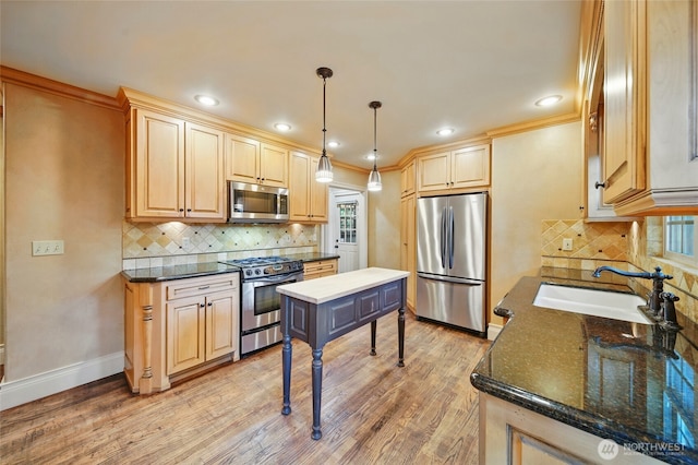 1126 E Alder St, Walla Walla, WA 99362 - kitchen with stainless steel appliances, a sink, light wood finished floors, baseboards, and crown molding