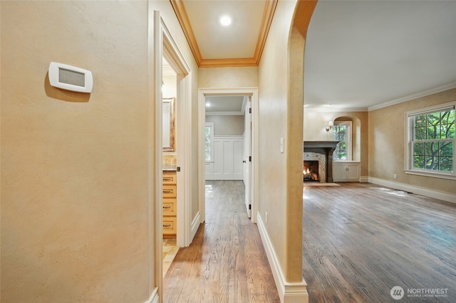 1126 E Alder St, Walla Walla, WA 99362 - corridor featuring arched walkways, ornamental molding, wood finished floors, a textured wall, and baseboards