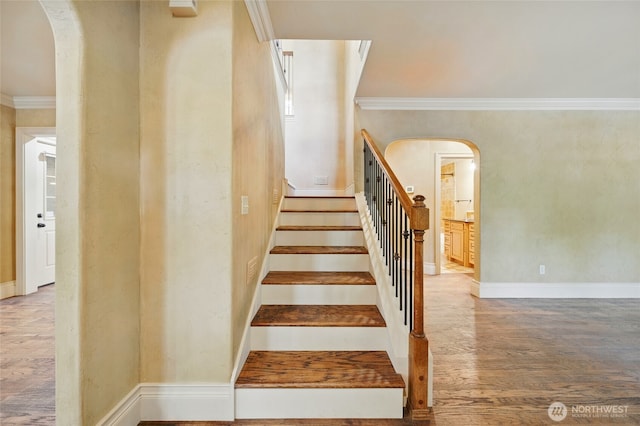 1126 E Alder St, Walla Walla, WA 99362 - stairway with arched walkways, ornamental molding, wood finished floors, and baseboards