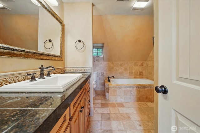 1126 E Alder St, Walla Walla, WA 99362 - bathroom featuring vanity, a garden tub, stone tile flooring, and toilet