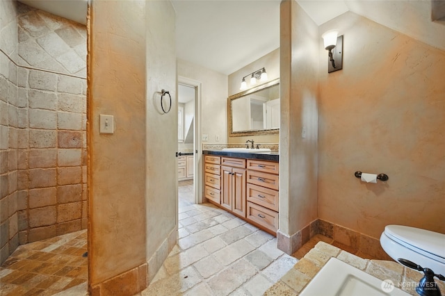 1126 E Alder St, Walla Walla, WA 99362 - bathroom with vanity, toilet, stone tile floors, and baseboards