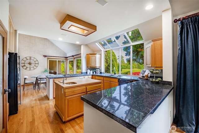 5419 Quail Run, Blaine, WA 98230 - kitchen featuring a peninsula, light wood finished floors, vaulted ceiling, tile countertops, and black appliances