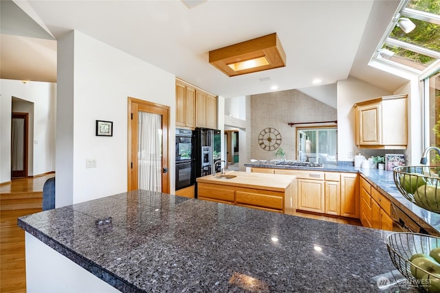 5419 Quail Run, Blaine, WA 98230 - kitchen with light brown cabinets, a peninsula, vaulted ceiling, tile counters, and a sink