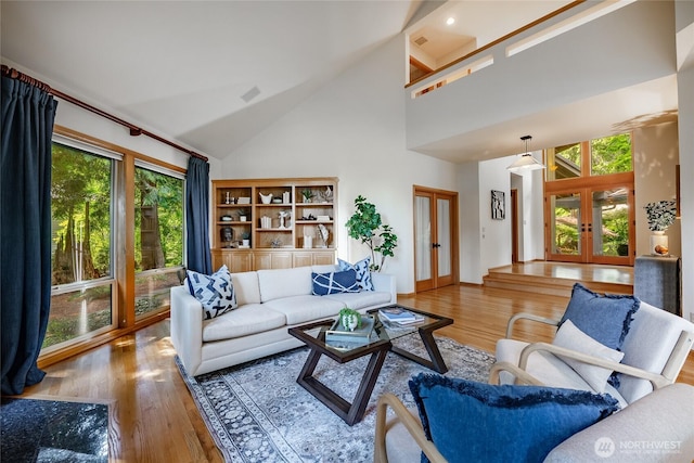 5419 Quail Run, Blaine, WA 98230 - living area featuring french doors, high vaulted ceiling, and wood finished floors