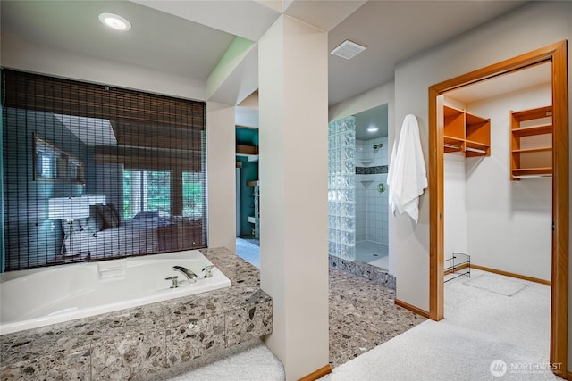 5419 Quail Run, Blaine, WA 98230 - bathroom featuring a walk in shower, a garden tub, baseboards, and a walk in closet